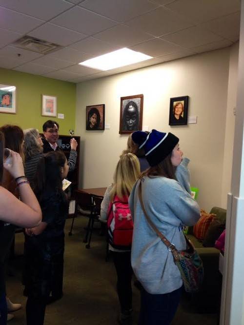 Crowd admiring art in the women's center